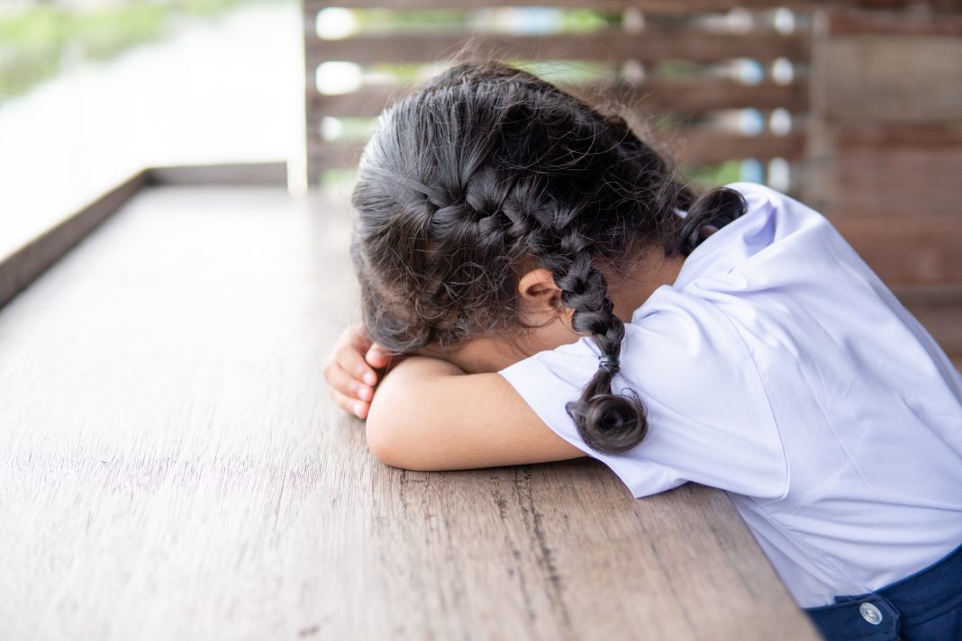Sad,Little,Girl,Sitting,On,Wooden,Table,And,Tired,With comportamientos