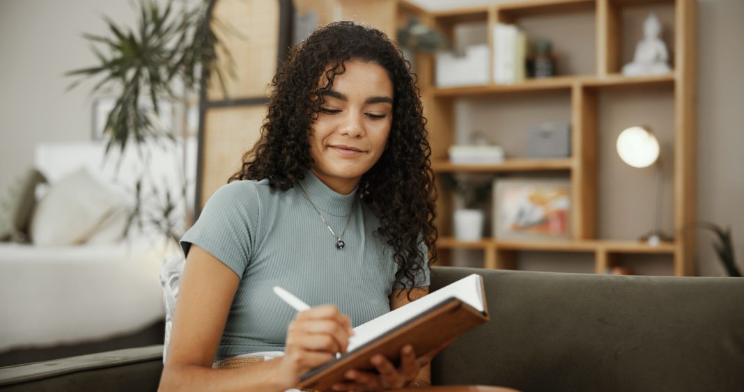 Writing,,Notebook,And,Smile,With,Woman,On,Sofa,For,Inspiration, gratitud
