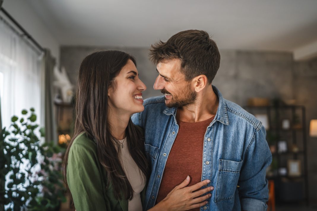 Portrait,Of,Beautiful,Couple,Stand,,Smile,And,Hug,At,Home
